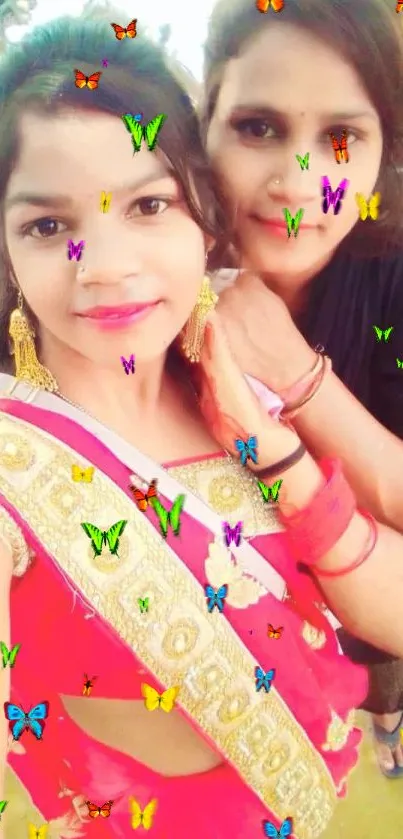 Two women in colorful traditional attire posing.