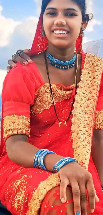 Woman in vibrant traditional red attire with intricate design.