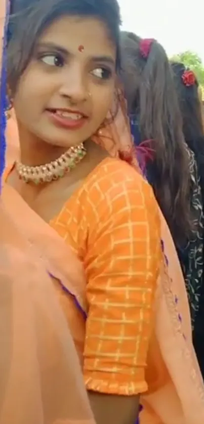 Woman in vibrant orange traditional attire.