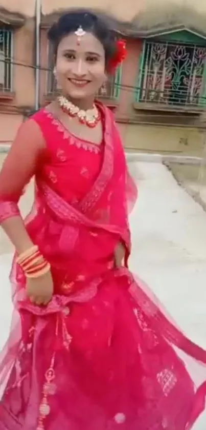 A woman in vibrant red traditional attire, exuding elegance.