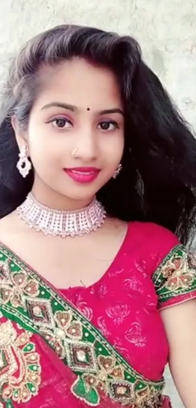 Woman in vibrant traditional attire with intricate embroidery.