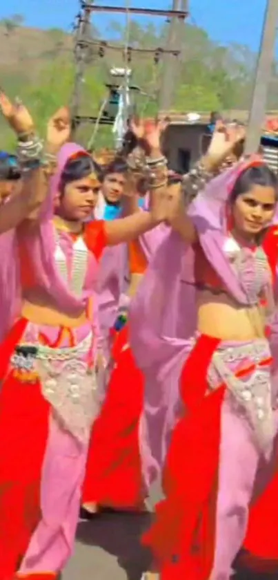 Women in colorful traditional attire dancing energetically at a festival.