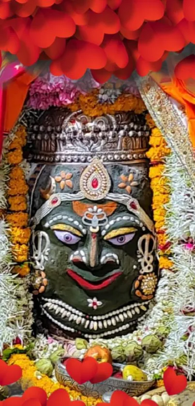 Hindu goddess with floral garland and colorful decor on wallpaper.