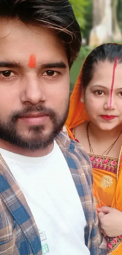 Vibrant portrait of a couple in traditional Indian attire with colorful background.