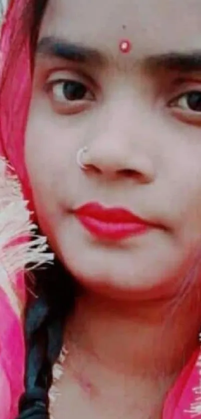 Vibrant portrait of a woman in pink traditional attire.