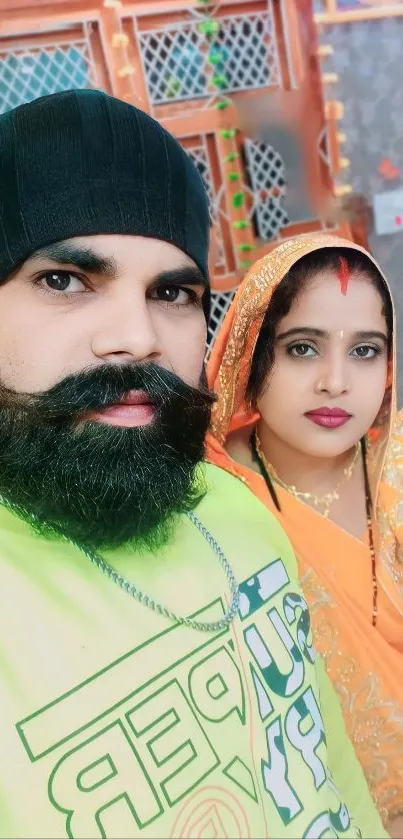 A vibrant portrait featuring a couple in traditional attire with colorful backgrounds.