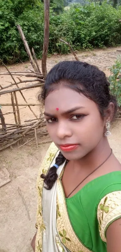 Portrait of a person in traditional attire with a green background.