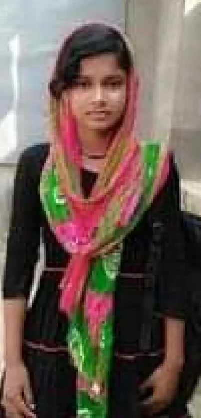 Young woman in vibrant traditional clothing with bicycle background.