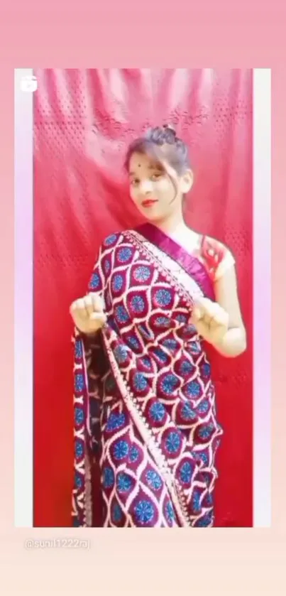 Vibrant wallpaper of a woman in a colorful sari against a red backdrop.