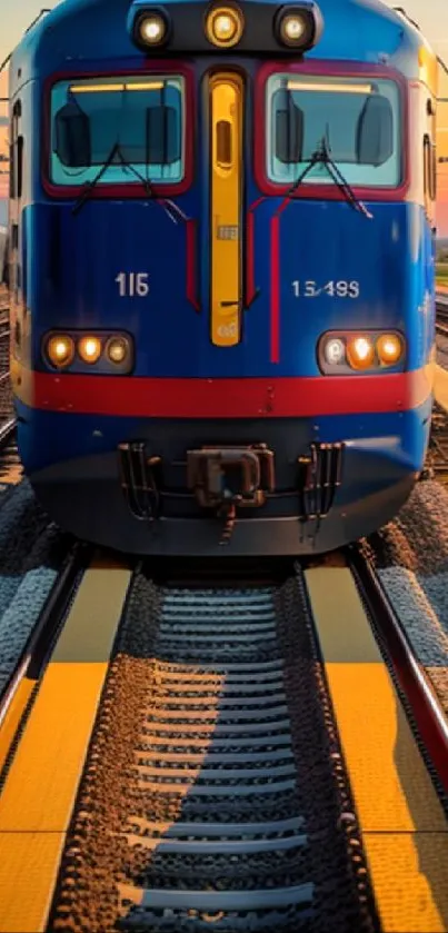 Blue train on tracks at sunset with vibrant sky.