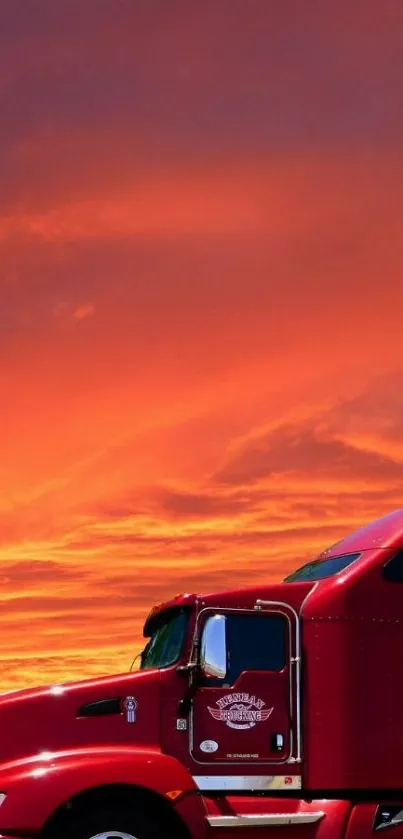 Red semi-truck under vibrant orange-red sunset sky.