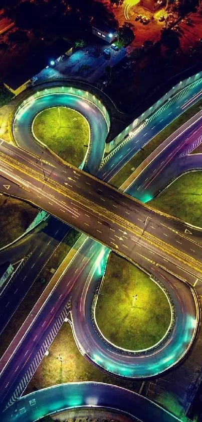 Aerial view of neon-lit highways at night, forming dynamic patterns.