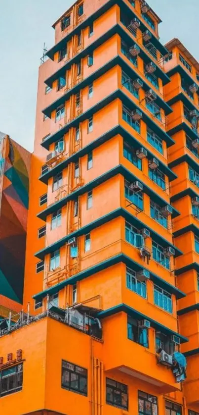 Bright orange building against a blue sky with geometric patterns.