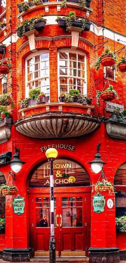 Vibrant red urban building with plants and classic design.