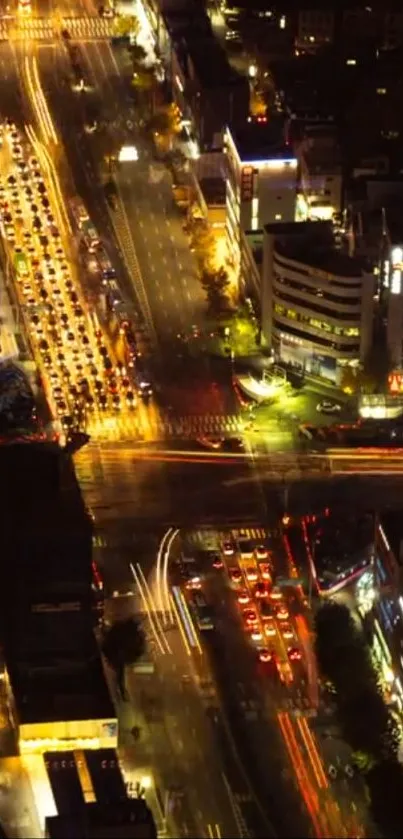 Aerial view of vibrant city streets illuminated at night.