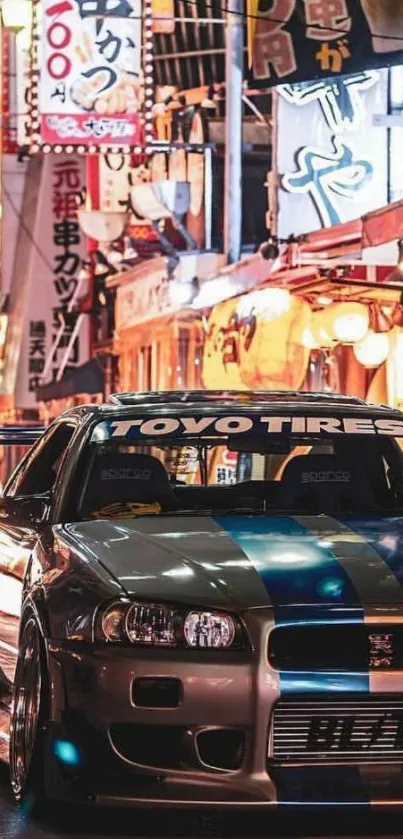 Sleek car in vibrant urban setting at night.