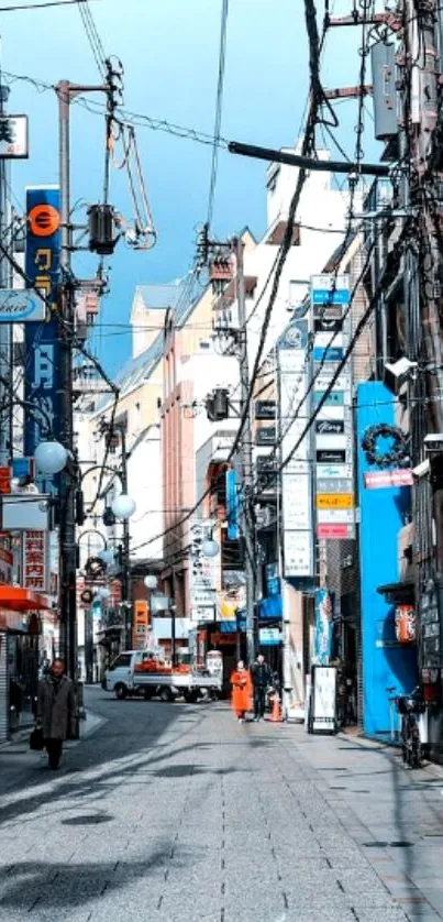 Vibrant urban street with colorful signs and electric wires.