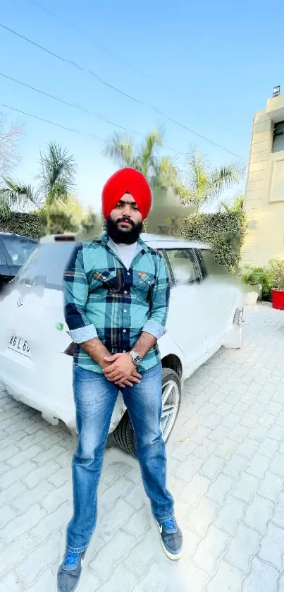 Person in vibrant attire standing with a car and building in the background.