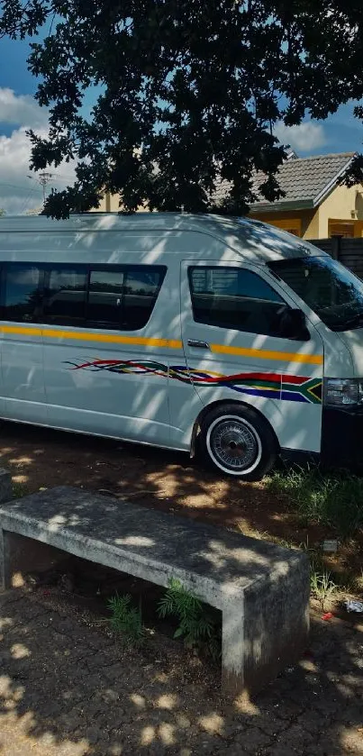 Urban van parked under trees in cityscape.