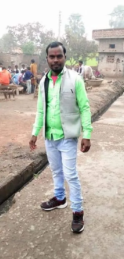 Man in neon green shirt on a village street bustling with activity.