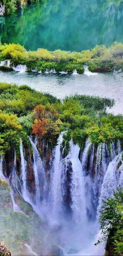 Scenic waterfall with lush green foliage and tranquil water view.