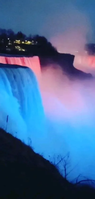 Blue and pink illuminated waterfall at night