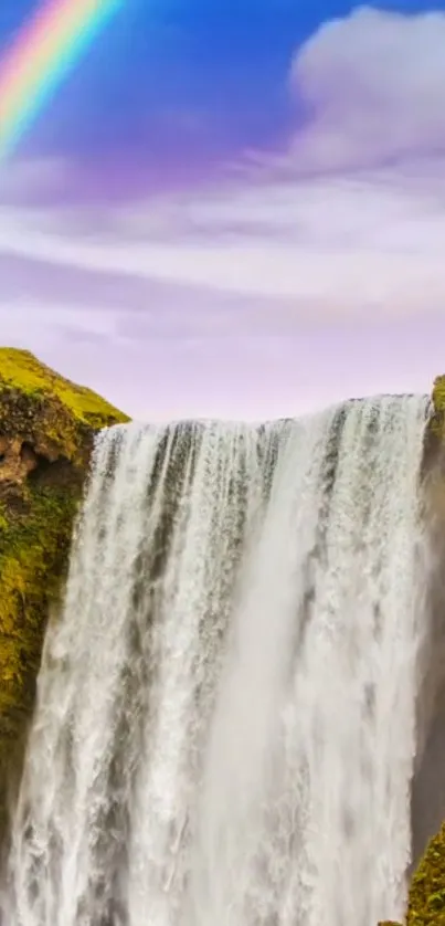 Waterfall with a rainbow in a vibrant nature scene.