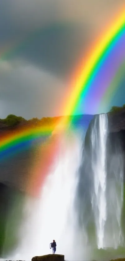 Dynamic waterfall with a vibrant rainbow arching over lush greenery on a phone wallpaper.