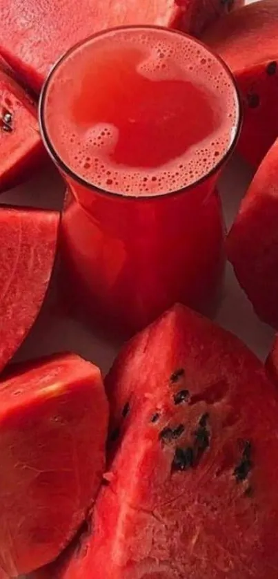 Vibrant watermelon slices around glass of juice.