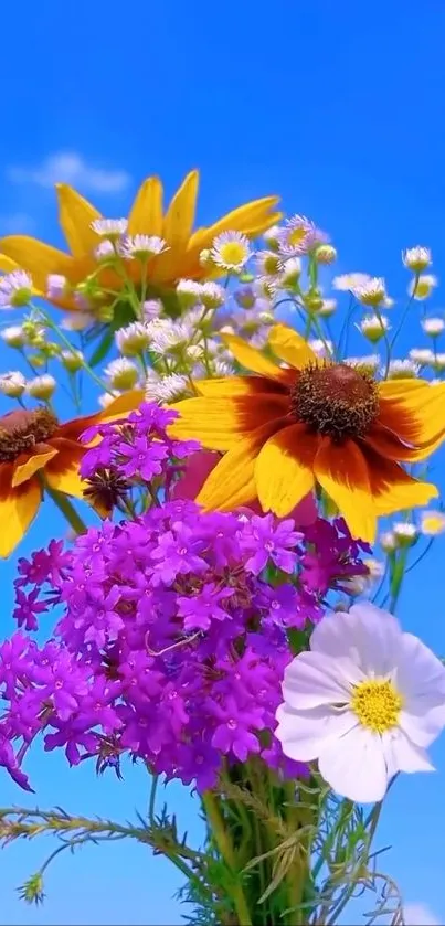 Vibrant wildflower bouquet with colorful blossoms against a blue sky.