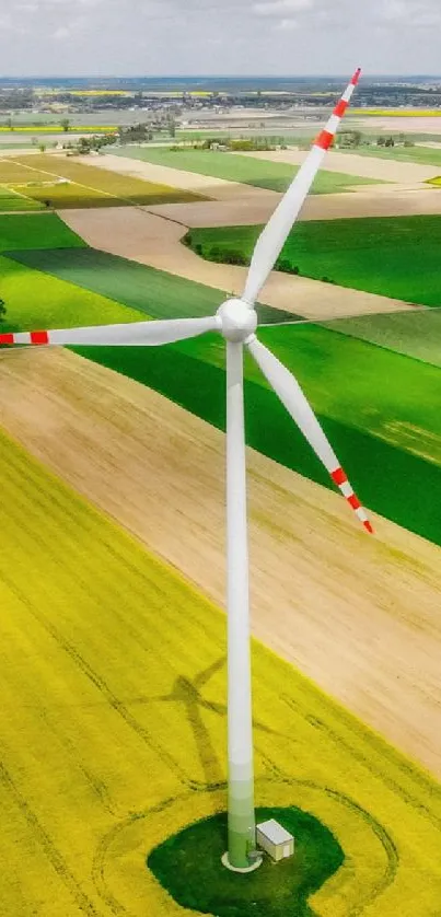 Aerial view of vibrant fields with wind turbines.