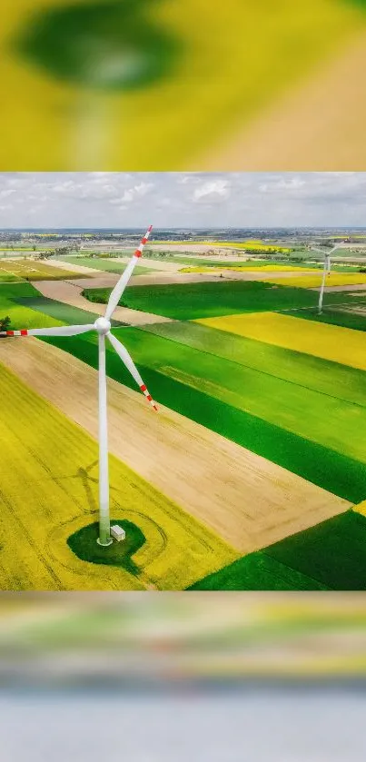 Aerial view of wind turbine over vibrant green and yellow fields.