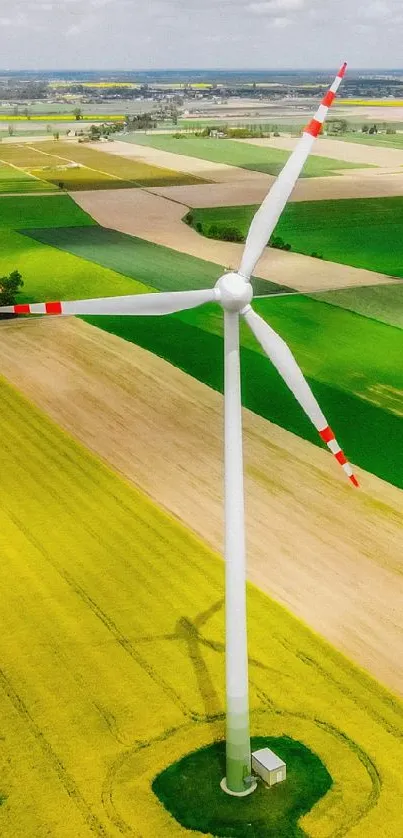 Aerial view of wind turbine in vibrant green fields.