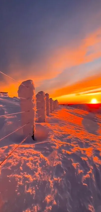 Vibrant sunset over snow-covered landscape, glowing orange sky.