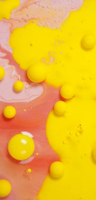 Vibrant yellow and pink abstract wallpaper with bubbles.