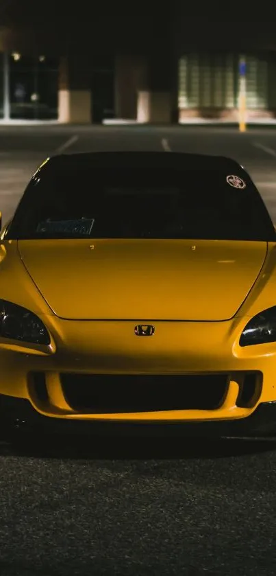 Vibrant yellow car in night setting.