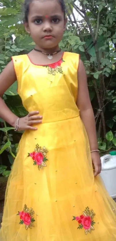 Young girl in a vibrant yellow dress with floral embroidery.