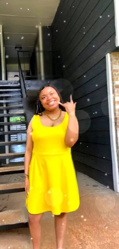 Person in vibrant yellow dress with stairs background.