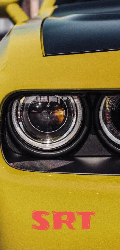 Yellow sports car close-up with distinctive headlights.