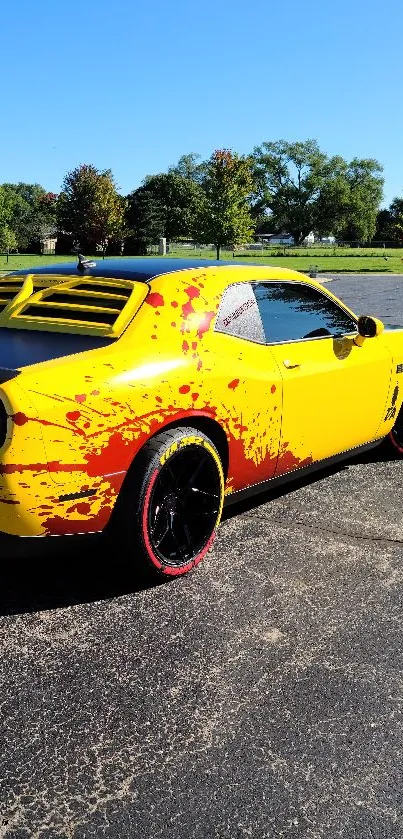 Vibrant yellow sports car with red accents in scenic outdoor setting.