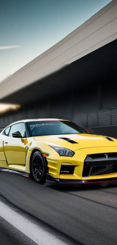 Yellow sports car on a race track at sunset.