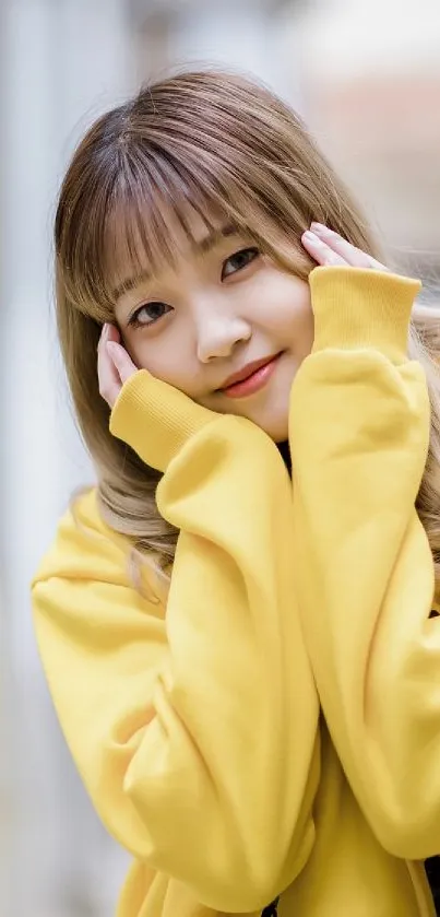 Person in yellow sweater posing on a bustling street.