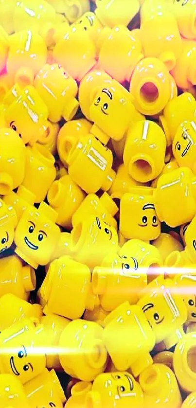 Vibrant yellow toy heads create a cheerful mobile wallpaper.