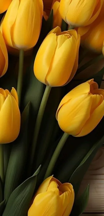 Vibrant bouquet of yellow tulips on wood.