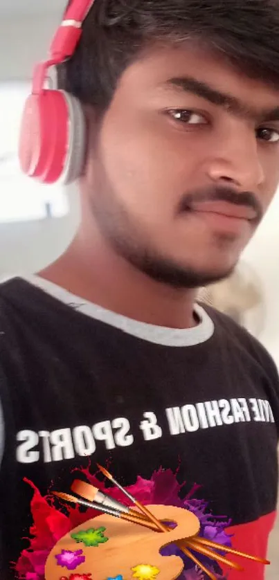 Young man with colorful headphones and art-inspired t-shirt.