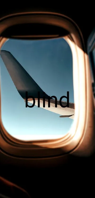 Airplane window view with wing and blue sky.