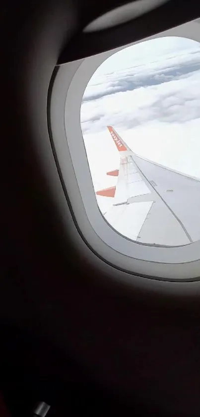 View of sky and clouds through an airplane window.