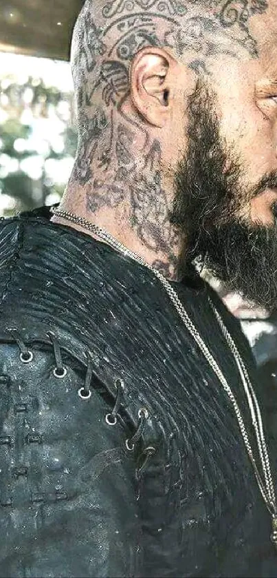 Viking warrior with tattoos and a beard, wearing leather armor.