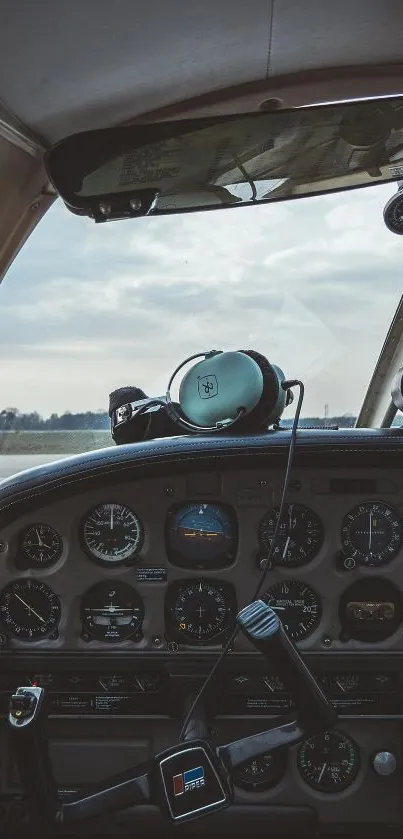 Vintage airplane cockpit with controls and sky view.