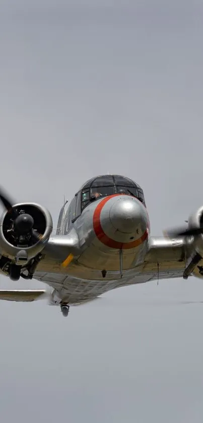 Vintage airplane soaring through a clear sky, showcasing classic aviation design.